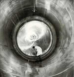 Brewing Prints: Ansells Brewery. A technician carrying out routine surface examination inside one
