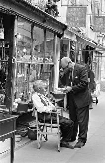 An antique dealers talking to a customer outside his shop in The Lanes in Brighton