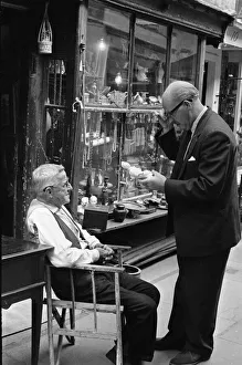 An antique dealers talking to a customer outside his shop in The Lanes in Brighton