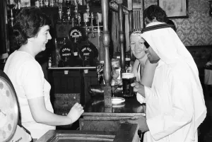 Keffiyeh Prints: Arab man enjoying a pint of Guinness at the Stanhope public house on Gloucester Road