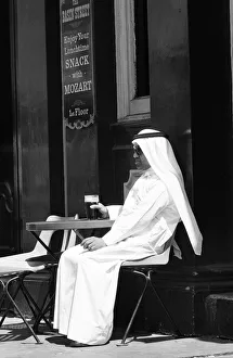 00443 Prints: Arab man sitting outside enjoying a pint of Guinness at the Stanhope public house