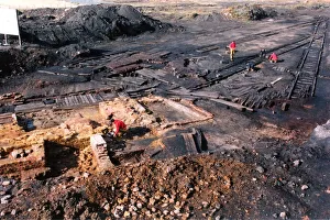 Archaeology Prints: Archaeologists digging up a perfectly preserved wooden railway which had lain buried