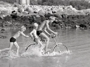 Arctic Summer in Northern Norway Children playing in the sea during one of