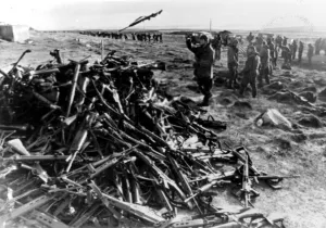 Falklands Prints: ARGENTINE SOLDIERS THROWING THEIR WEAPONS ONTO A PILE AT PORT STANLEY AFTER SURRENDERING