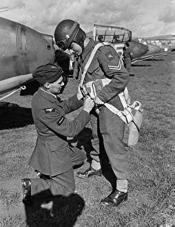 00113 Prints: Army Airborne: R. A. F makes certain the pupil known how to fix her chute