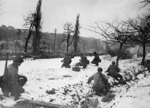 01458 Prints: US Army engineers crouch in the foreground as a TNT charge breaks up the ice in