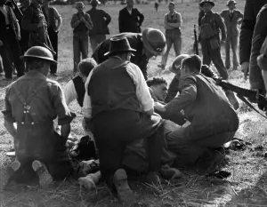 Captured Prints: Army and FAP members attend to a German pilot in England who parachuted to the ground