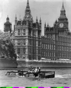 Army Vehicles. Amphibious. Two Army trucks transport three waving women through