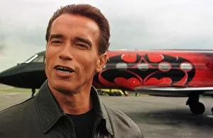 Arnold Schwarzenegger arrives at Luton Airport with wife Maria in Batplane