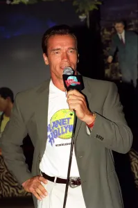 00138 Prints: Arnold Schwarzenger Actor July 98 At Planet Hollywood restaurant in london holding