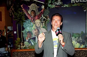 00139 Prints: Arnold Schwarzenger Actor July 98 At Planet Hollywood restaurant in london holding