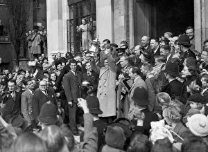 Arsenal captain Joe Mercer holds up the FA cup trophy on the steps of Islington Town Hall