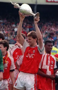 Arsenal captain Tony Adams lifts the League Championship trophy after they defeated
