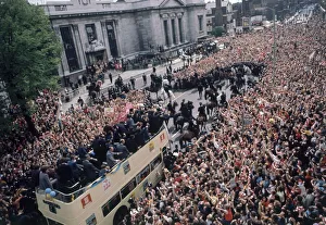 The Arsenal football team bus returns to a rapturous reception by thousands of fans