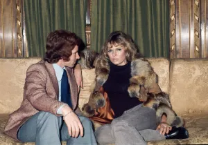 Arsenal footballer Alan Ball sitting on a sofa talking to actress June Ege during a team