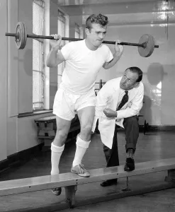 Weights Prints: Arsenal physiotherapist Bertie Mee watches intently as Hendon outside right Terry Howard
