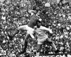 Arsenal v. Leeds: Roberts (Arsenal) jumps high to head over Belfitt (Leeds)