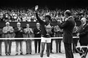 Arthur Ashe receives the trophy from the Duke of Kent after he defeated the defending