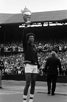 Sports Venue Prints: Arthur Ashe with the Wimbledon trophy after he beat the defending champion Jimmy Connors