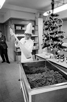 Arthur Askey, the famous little comedian stirred up a giant Christmas pudding today at a