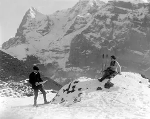 Artist Adrian Allison painting his wife on skis on the mountain slopes at Murren