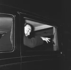 Artist Salvador Dali who recently arrived in the UK, on the continental boat train to