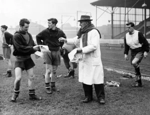 Assistant Trainer Bill Inglis handing out shirt numbers to Mark Pearson (left)