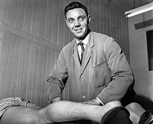 00246 Prints: Assistant trainer Joe Fagan massages the legs of Peter Thompson in the medical room