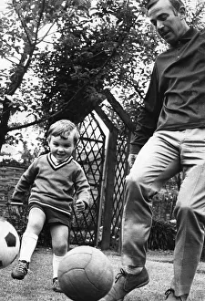 Kicking Prints: Aston Villa footballer Ron Wylie playing with his son Nigel. 15th June 1968