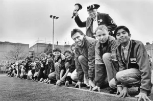 Athlete Dave Moorcroft with pupils on the new all-weather pitch at Sidney Stringer school