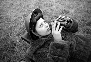 An ATS woman using a pair of binoculars on searchlight Battery January 1943