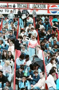 Audience gather outside the Wembley arena prior to the Michael Jackson concert