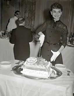 Formal Evening Prints: Audrey Hepburn May 1953 Film actress cuts into her Welcome home cake