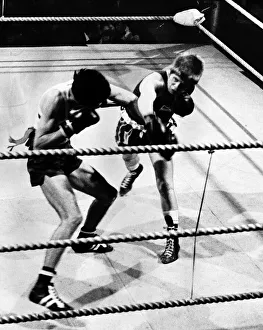Aurel Dumitrescu reels from a powerful right from Charlie Parvin