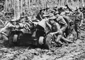 Australian-made 25 pounder being manhandled through the mud at Langemak Bay New Guinea