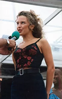 Images Dated 7th August 1992: Australian pop singer Kylie Minogue performing on stage at the BBC Radio One Roadshow