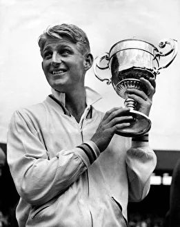 Australian tennis player Lew Hoad holding the championship cup after his finals match