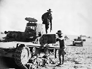 Australian Prints: Two Australians inspect Italian tanks abandoned in the Western Desert. December 1940