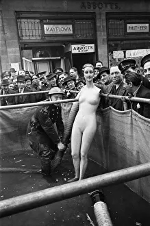 01491 Prints: Auxiliary fireman seen here inspecting a water supply tank outside an Abbotts Shoe Shop