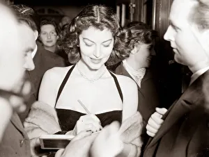 Ava Gardner signing autographs at a Midnight Matinee at the Colliseum, December 1951