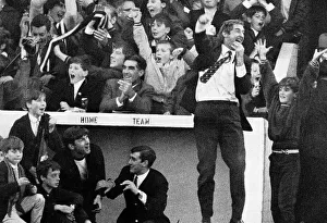 Dugout Prints: Ayr United manager Ally MacLeod jumps into the air outside the dug-out wearing a blazer
