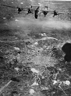 United States Air Force Prints: A B-24 Liberator bomber of the 15th US Air Force flies over the battered city of Bologna