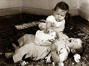 Birthdays Prints: Two babies enjoying their birthday cake. Circa 1950 NO USE FOR GREETINGS