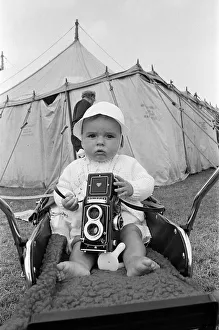 Babies Prints: A baby sitting with a Rolleiflex camera at Skelton annual baby show. Circa 1973