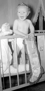 Presents Prints: Baby Stephen Reynolds with his Christmas Stocking December 1954 Neg No E9179