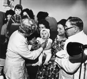 Diseases Prints: A baby being vaccinated at Halton Road divisional health centre in Runcorn