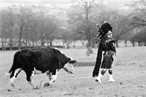 Bagpiper Craig McIntosh practises playing his bagpipes in a field