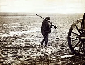 Balkan war 1912 A Turkish refugee walking on the mire of the high road to