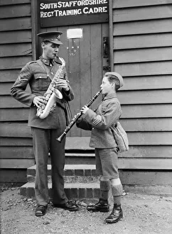 A bandsman of the South Staffordshire Regiment seen here rehearsing with a boy soldier