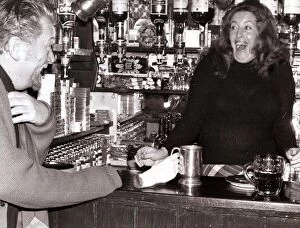 Images Dated 11th January 1975: A barmaid at the Red Lion Pub in Kings Langley, Hertfordshire laughing after customer